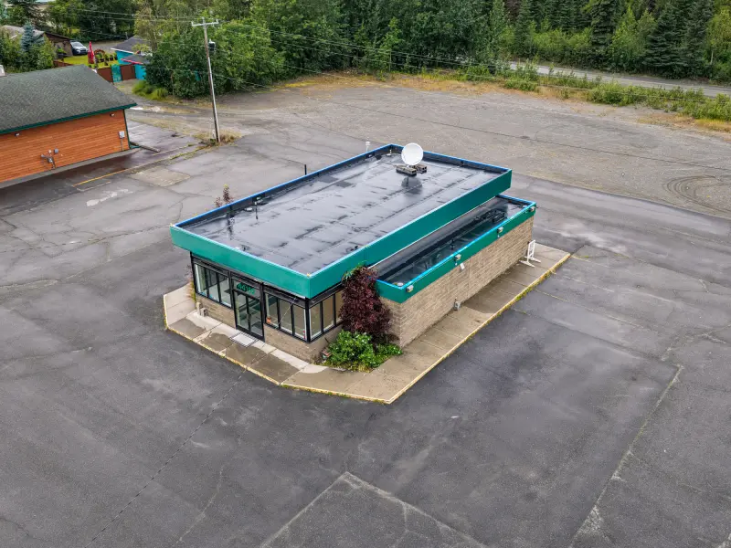 Aerial view showing parcel depth and rear commercial grounds